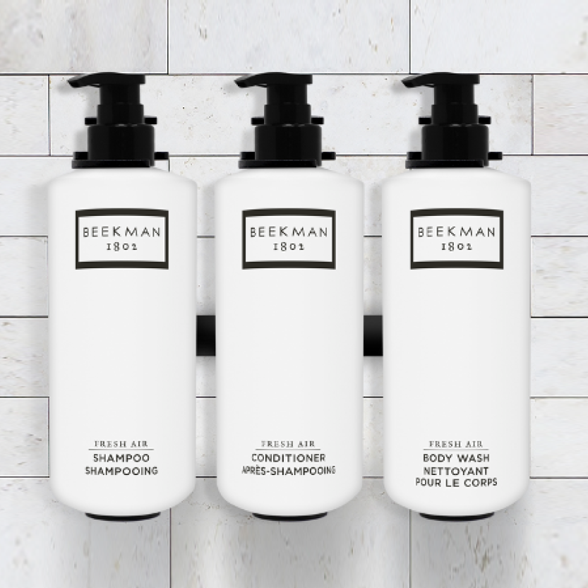 Three Beekman 1802 bottles are displayed, they are labeled shampoo, conditioner, and body wash.